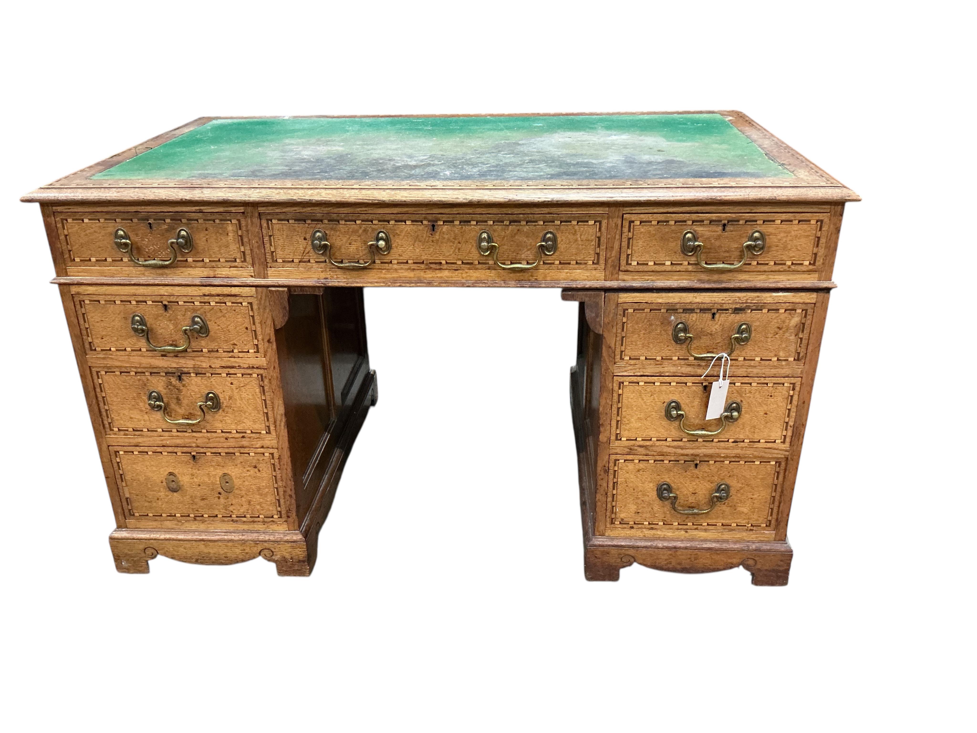 A late Victorian parquetry inlaid oak pedestal desk bears ivorine label Robson & Sons, Newcastle-on-Tyne, width 129cm, depth 76cm, height 76cm